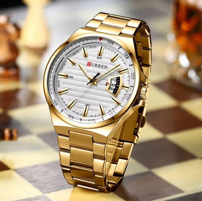 Gold wristwatch with a white face on a checkered surface