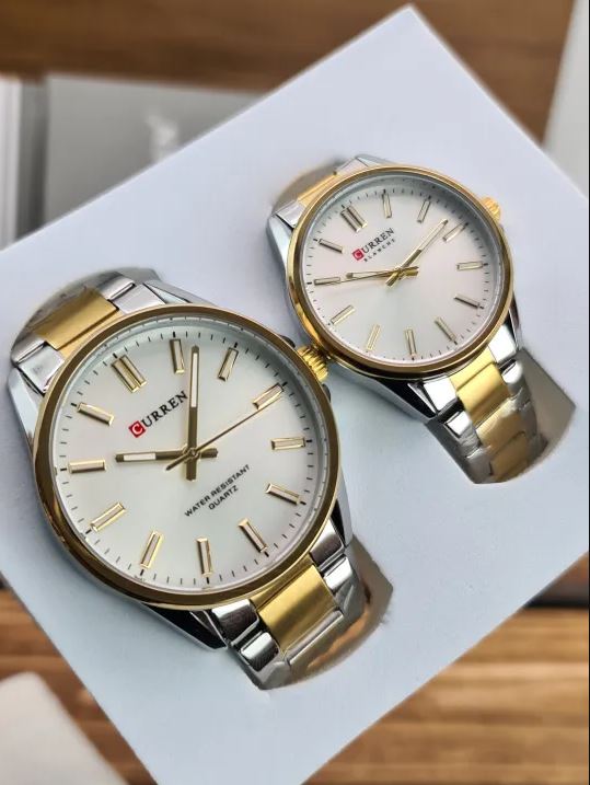 Two watches with gold and silver straps on a white surface.