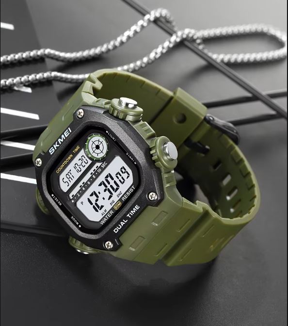 Green digital watch with black display on a dark surface
