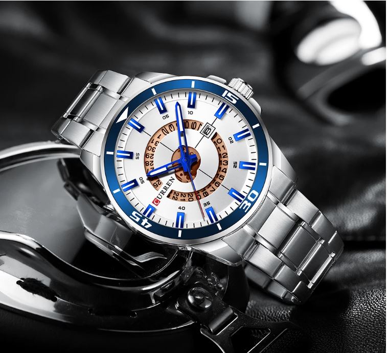 Silver wristwatch with a detailed face on a dark background