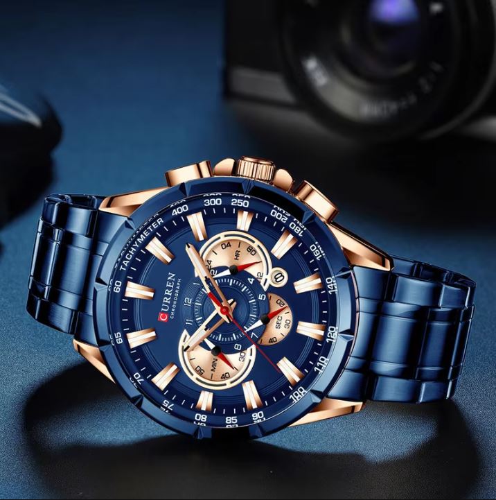Blue and rose gold watch on a dark background