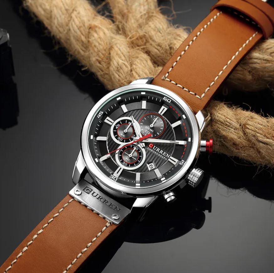 Curren watch with brown leather strap on a dark background