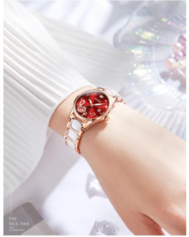 Rose gold watch with a red face on a white background