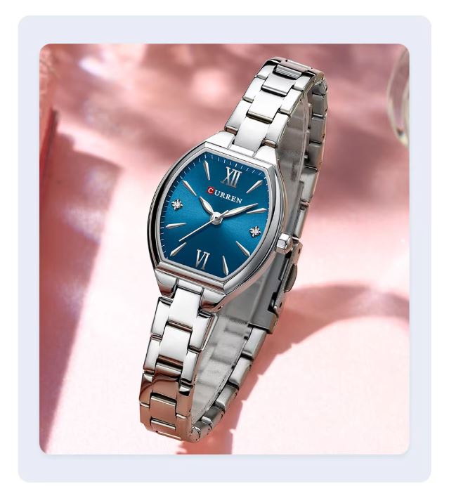 Silver watch with a blue dial on a pink background