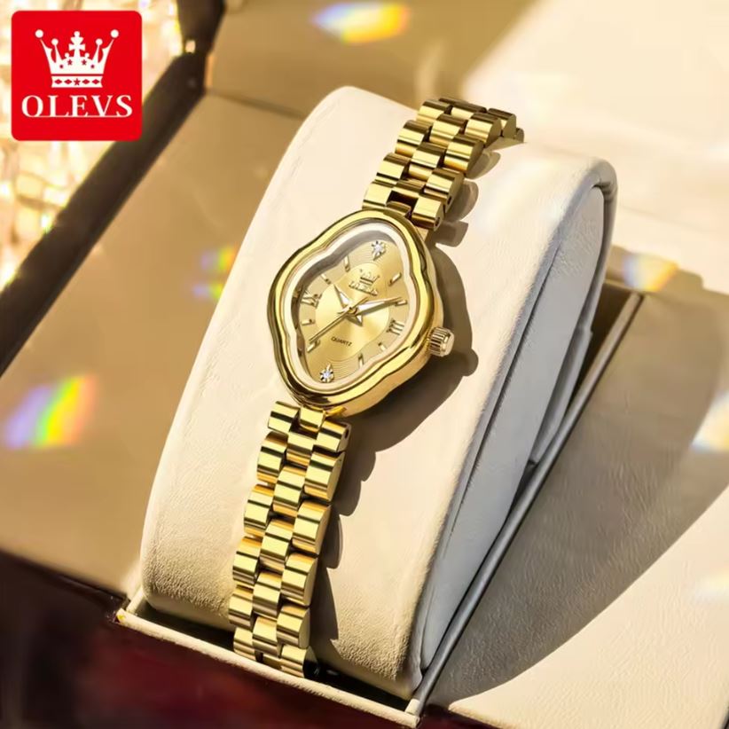 Gold watch on a display stand with OLEVS branding