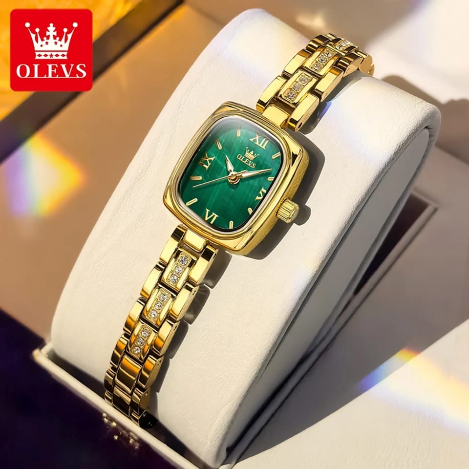 Gold watch with green face in a box, branded OLEVS