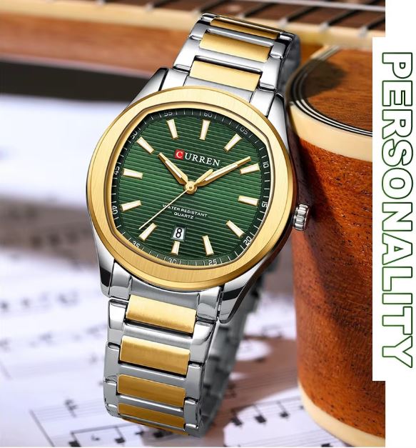 Two-tone watch with green dial on a background of a guitar and music sheet
