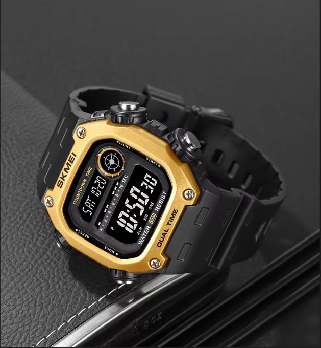 Digital watch with gold and black design on a dark background