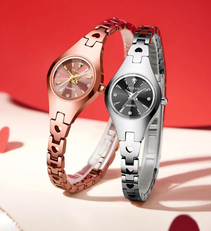 Two watches, one rose gold and one silver, on a red and white background.