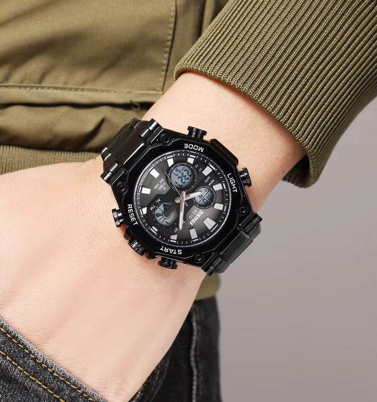 Black wristwatch on a person's wrist with a neutral background