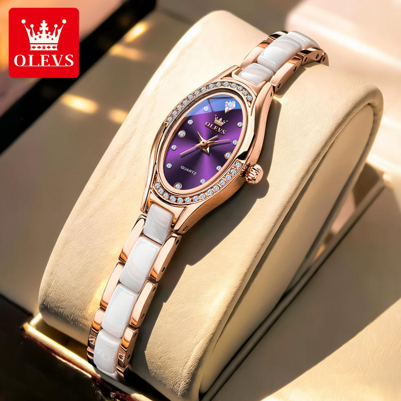 Luxury watch with purple dial and white strap on a gold stand, featuring OLEVS branding.
