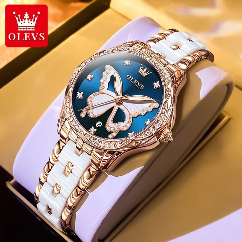 Luxury watch with butterfly design on a white strap, branded OLEVS.