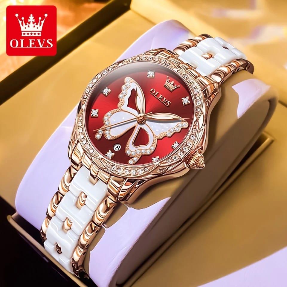Luxury watch with butterfly design on a white strap, branded OLEVS.