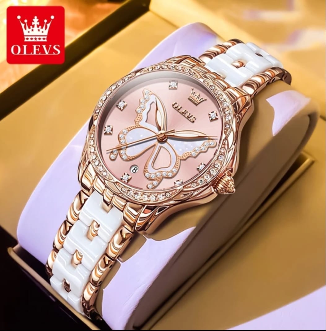 Luxury watch with white strap and rose gold casing on a gold surface, OLEVS brand visible.