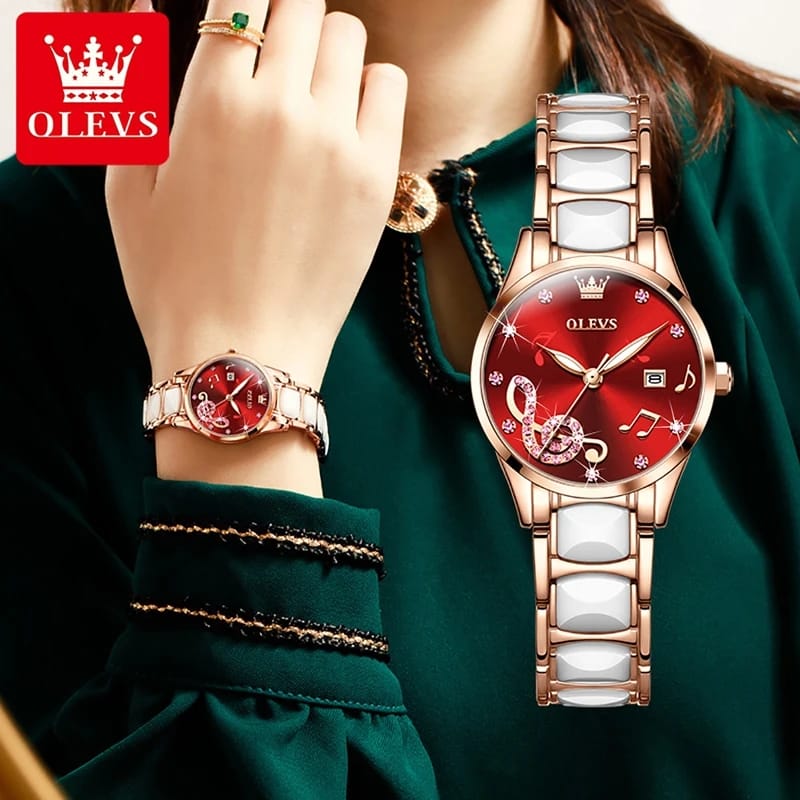 Red OLEVS watch on a wrist with a green background