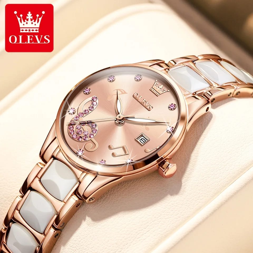 Rose gold watch with white ceramic strap on a beige background, featuring the OLEVS brand.