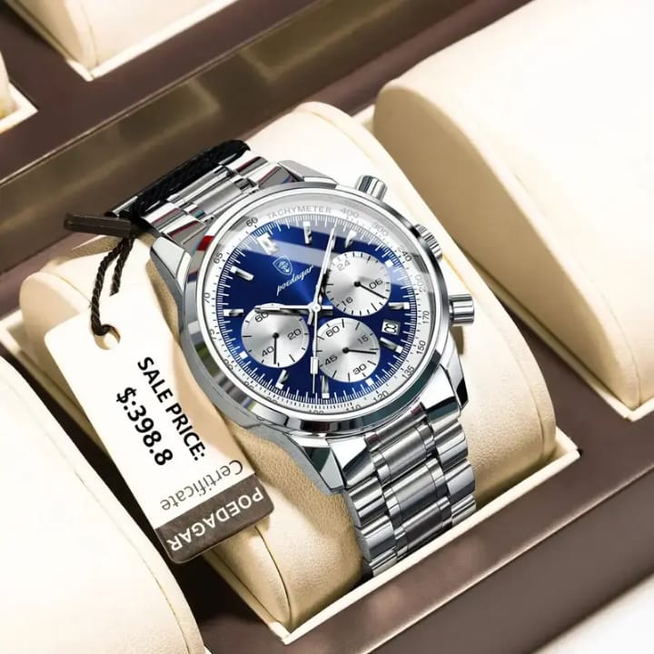 Silver watch with blue face in a box, tag showing sale price.