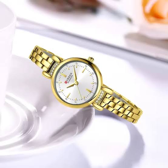 Gold wristwatch on a white background