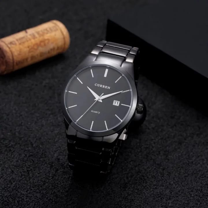 Black Curren watch on a dark textured surface