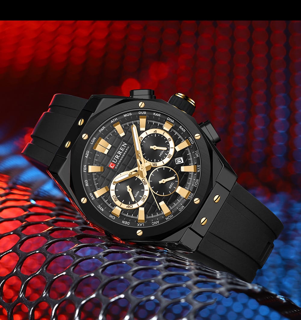 Black and gold watch on a red and blue textured background