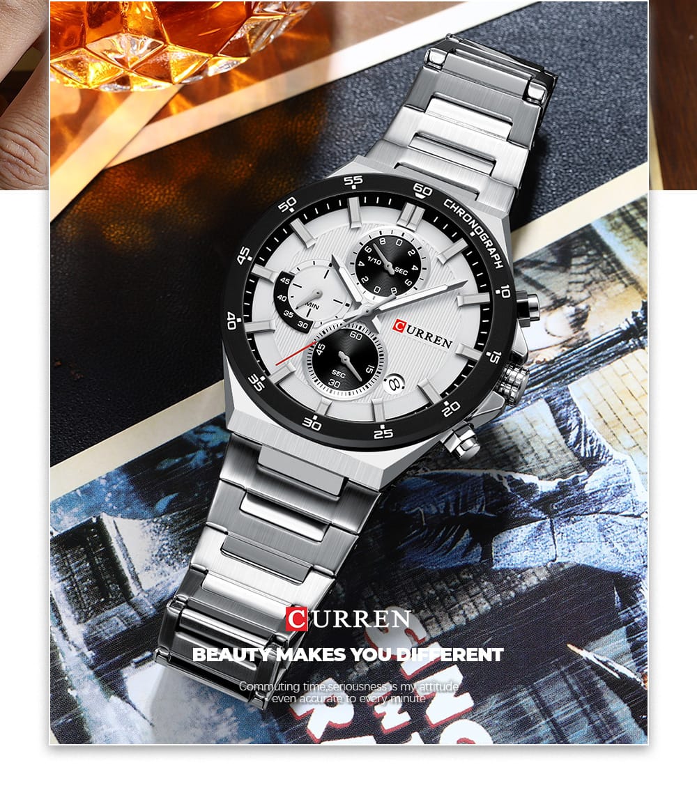 Silver wristwatch with a detailed face on a magazine page background