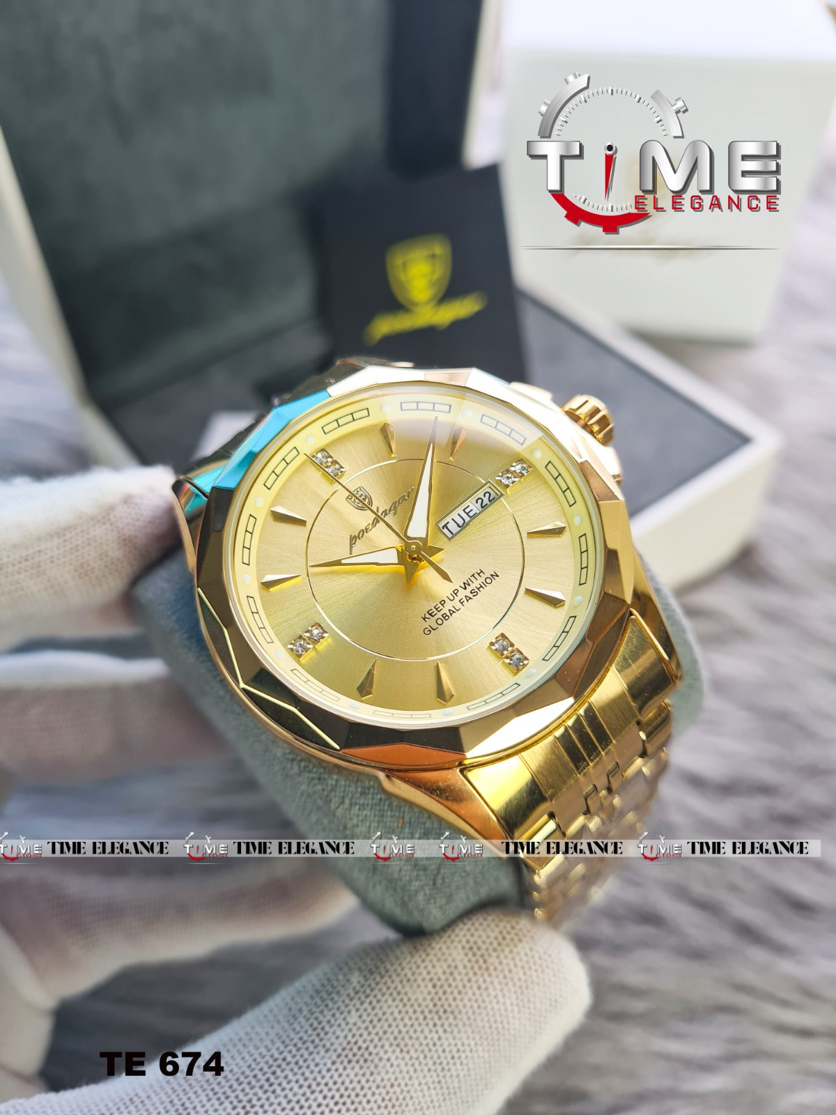 Gold wristwatch with a brand logo in the background