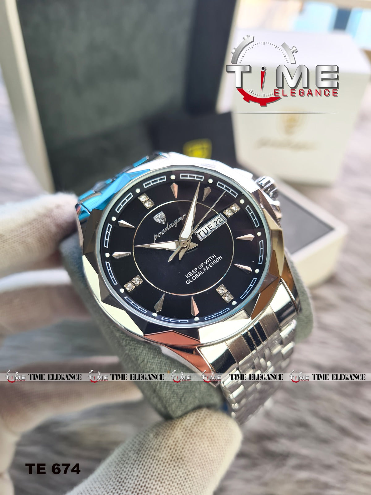 Watch with a black face and silver case held by a hand, with 'Time Elegance' branding.