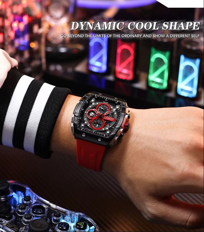 Person wearing a red watch with a dynamic cool shape design, set against a blurred background.