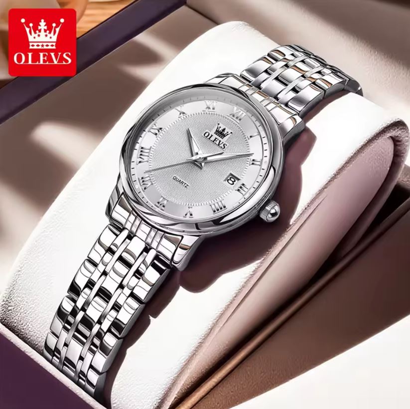 Silver wristwatch with a purple face on a soft surface, branded 'OLEVS'.