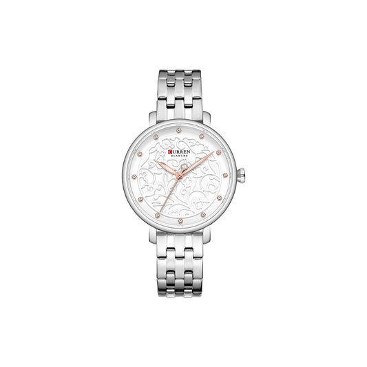 Silver watch with floral design on the dial against a white background