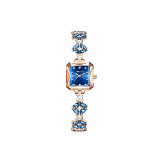 Luxury watch with blue gemstones on a white background