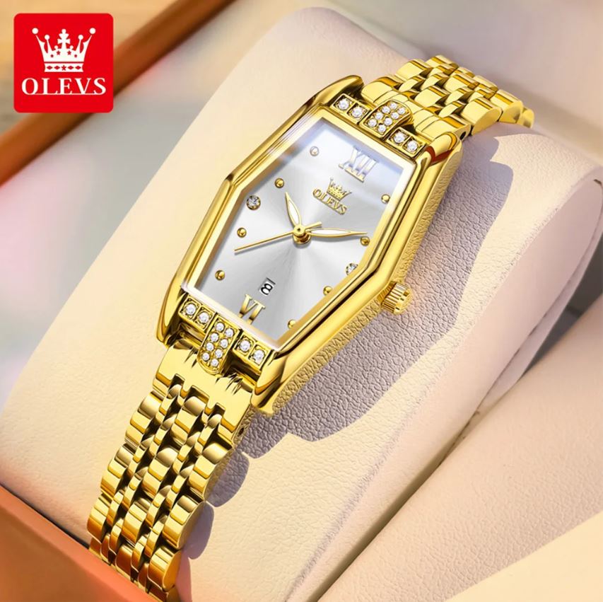 Gold wristwatch with diamond accents on a soft surface, brand 'OLEVS' visible.