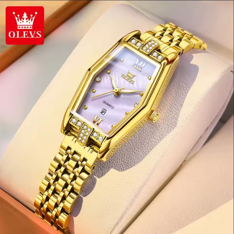 Gold wristwatch with diamond accents on a soft surface, brand 'OLEVS' visible.
